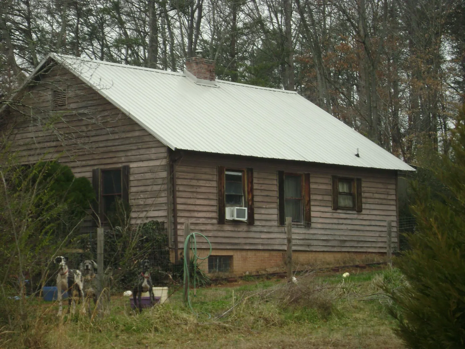 White metal roof on an old wood sided farmhouse, from a Metal Roof Installation job in Mountain View